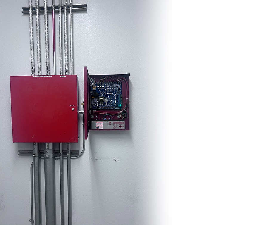 Fire alarm cabinet and open control panel showing the connected wiring